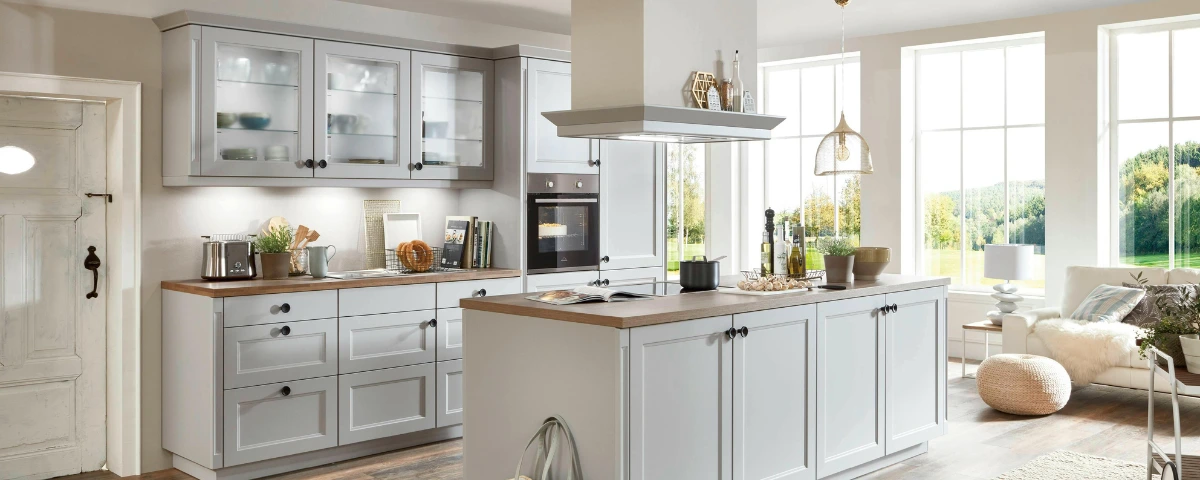 A newly renovated, spacious kitchen with a large central island, double ovens, and ample cabinet space, showcasing the benefits of buying a bigger home.