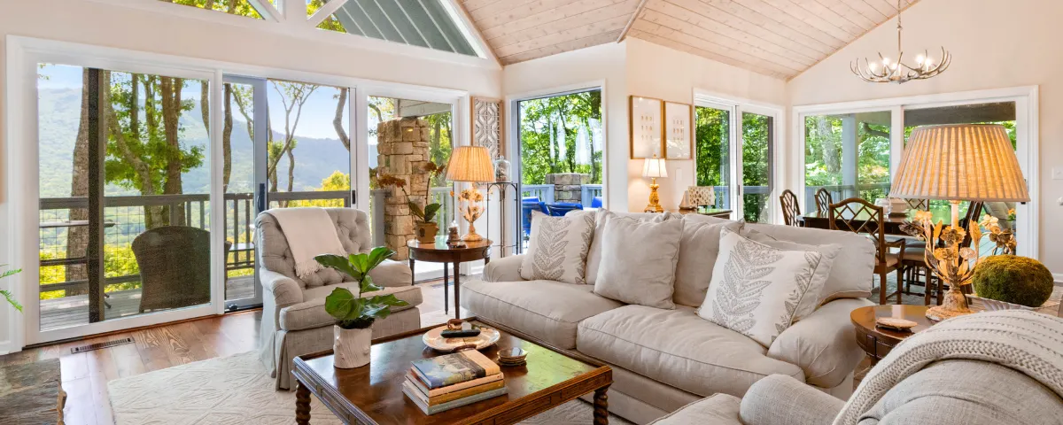 Bright and airy living room featuring vaulted ceilings and large windows overlooking the Austin Hill Country, symbolizing the transition to a larger, more comfortable home.