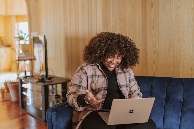 woman_using_a_laptop_while_sitting_on_a_sofa