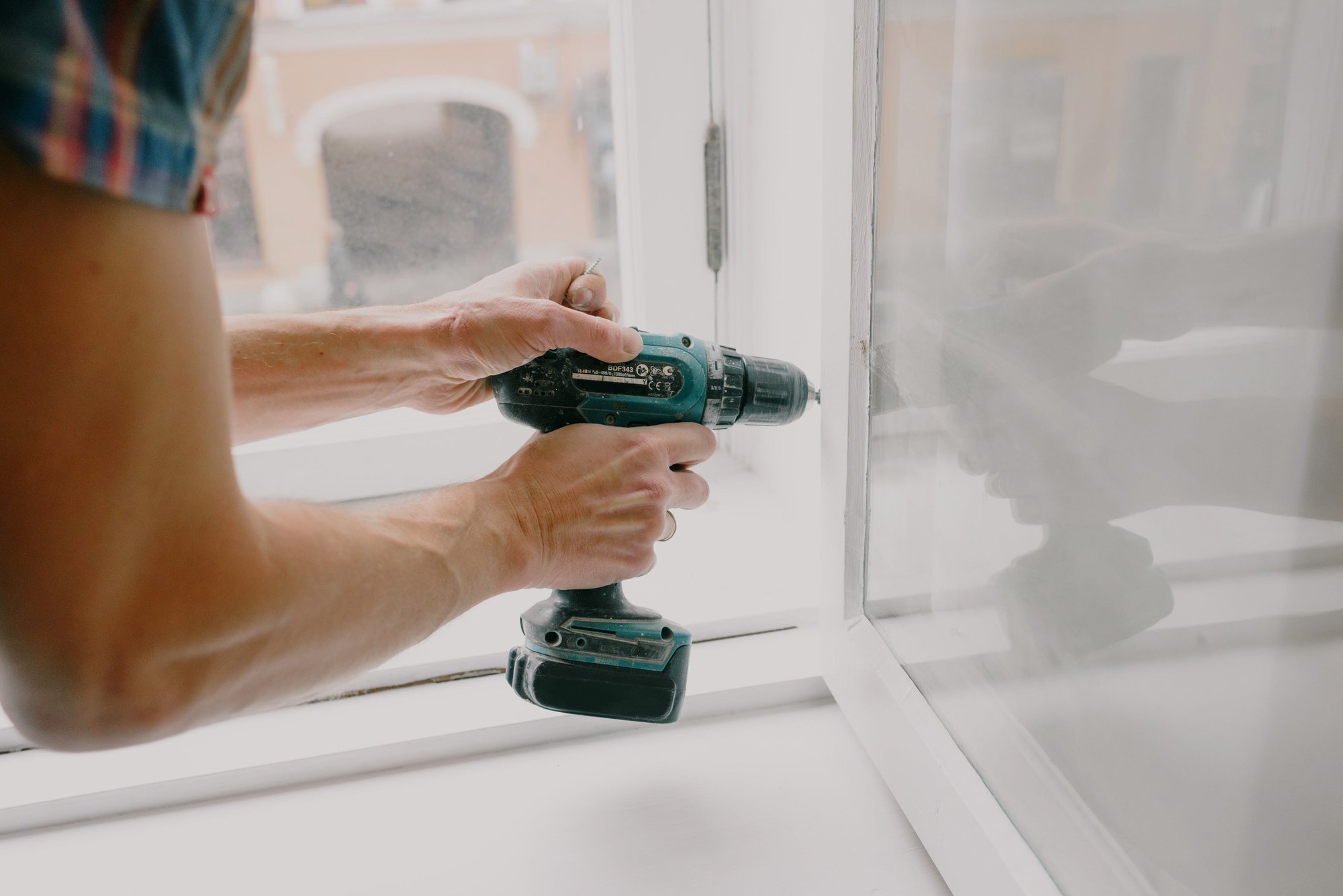 person drilling a door